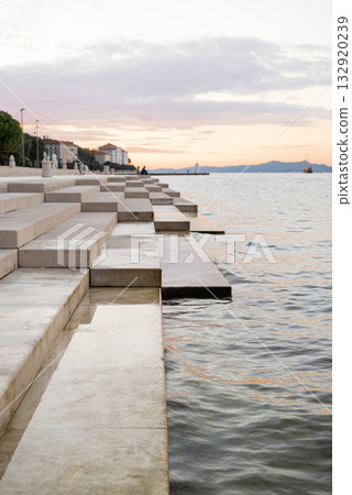 Zadar Croatia, embankment in the city center on the beoegu of the sea steps of the sea organ on a sunset Zadar Croatia, embankment in the city center on the beoegu of the sea steps of the sea organ on a sunset 132920239