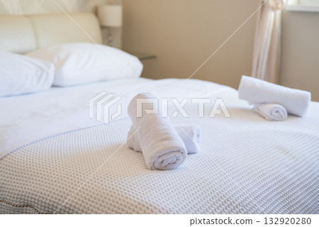 neatly folded towels on the beds in the hotel room service and hotel cleaning 132920280