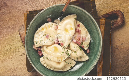 Dumplings, with fried prosciutto, a traditional dish of Polish cuisine, dumplings, top view, close-up, without people, 132920513