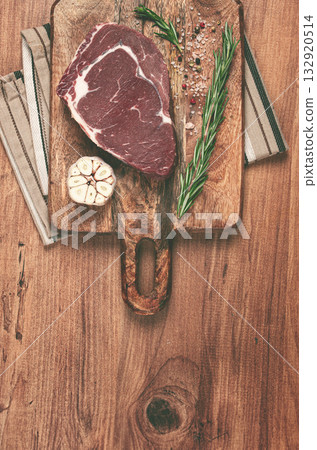 raw steak, beef steak, rib eye steak, on a cutting board, freshly frozen, on the table, top view, raw steak, beef steak, rib eye steak, on a cutting board, freshly frozen, on the table, top view, 132920514