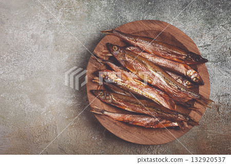 cold smoked capelin, on a wooden bowl, top view, no people, 132920537
