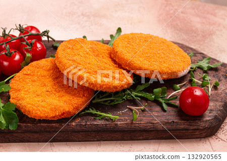 crispy fried fish cutlets, fish burgers, on a wooden chopping board, with arugula and cherry tomatoes, homemade, no people, 132920565