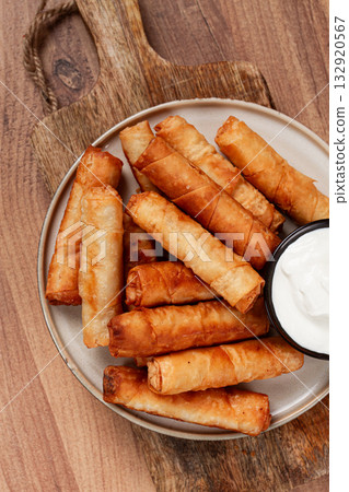 fried spring rolls with cheese, on a wooden background, with cream sauce, no people, fried spring rolls with cheese, on a wooden background, with cream sauce, no people, 132920567