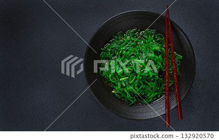 Chuka salad, made from fresh seaweed, with sesame dressing, served in a black bowl, with chopsticks, Chuka salad, made from fresh seaweed, with sesame dressing, served in a black bowl, with chopsticks, 132920570