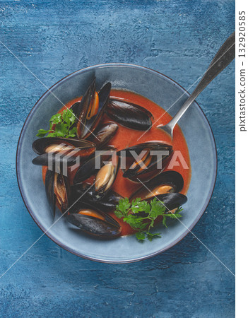 Fra Diavolo mussels, mussels in tomato sauce, Italian dish, on a blue background, homemade, no people, Fra Diavolo mussels, mussels in tomato sauce, Italian dish, on a blue background, homemade, no people, 132920585