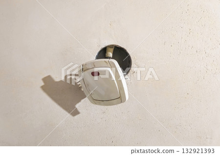 Dismantling the old wall switch.  Close-up. 132921393