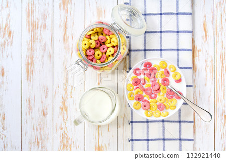 Healthy breakfast, bowl of colorful corn rings with milk . Top view. 132921440