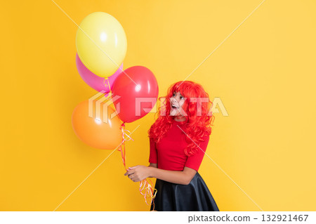 positive child with party balloon on yellow background 132921467