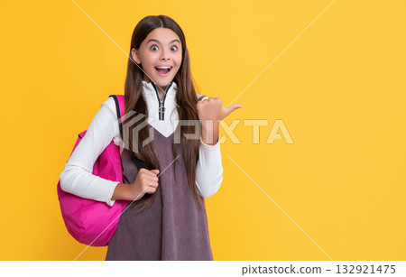 surprised child with school bag on yellow background 132921475