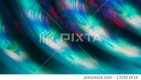 Defocused droplet oil. Color mix. Green orange blue ink water texture round flow bubbles pour on abstract acrylic neon light art background. 132921619