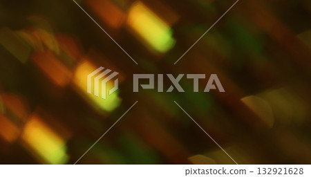 Defocused shimmering flare. Gradient light. Colorful glitter twinkle texture mixing beam. Optical reflection on dark abstract background. Defocused shimmering flare. Gradient light. Colorful glitter twinkle texture mixing beam. Optical reflection on dark abstract background. 132921628