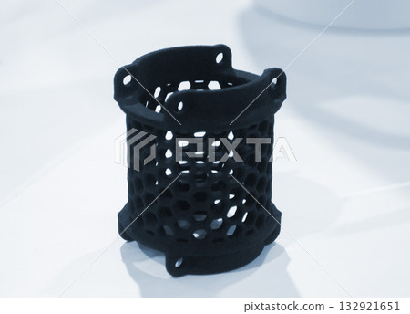 Object printed on 3D printer from molten plastic powder close-up. Model printed on 3D printer from melted polyamide powder. New modern additive 3D printing technology. Multi Jet Fusion MJF technology Object printed on 3D printer from molten plastic powder close-up. Model printed on 3D printer from melted polyamide powder. New modern additive 3D printing technology. Multi Jet Fusion MJF technology 132921651