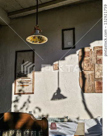 Wall with lamp shadows, table, chairs 132921759