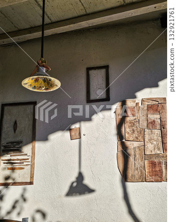Long lamp with shadows on wall Long lamp with shadows on wall 132921761