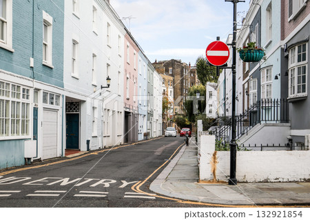 Quiet urban street with pastel-colored houses and a red no entry traffic sign. Architecture, city 132921854