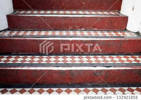 Vintage Red and White Tiled Staircase Pattern. Architectural detail, symmetry, and classic design Vintage Red and White Tiled Staircase Pattern. Architectural detail, symmetry, and classic design 132921858