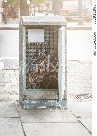 Open street utility box showing tangled electrical cables and components. Urban infrastructure 132921860