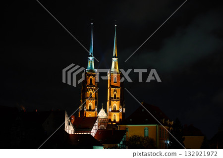 Illuminated cathedral towers at night in cityscape 132921972
