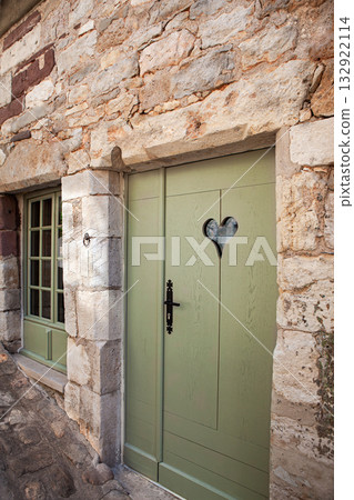 Facade of a stone typical and rustic French house 132922114