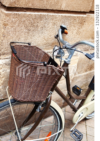 Parking an urban bicycle against a stone wall 132922118