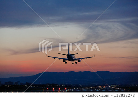 A small plane landing in the evening sky 132922278