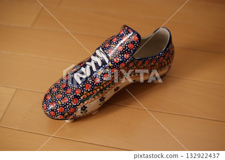 A floral-patterned ceramic soccer cleat ornament stands out in the interior A floral-patterned ceramic soccer cleat ornament stands out in the interior 132922437