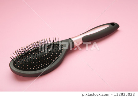 Massage hairbrush on pink background. Space for text 132923028