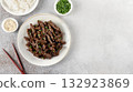Asian-style beef stir fry with teriyaki sause, sesame seeds, green onions and rice. Top view, copy space. 132923869