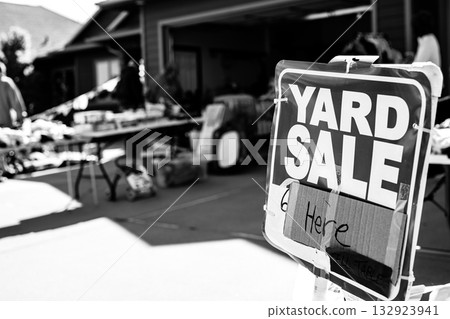 Selective focus on a yard sale sign with blurred tables of material Selective focus on a yard sale sign with blurred tables of material 132923941