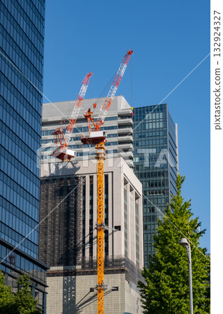 Looking up at the skyscrapers and tower cranes in Marunouchi Looking up at the skyscrapers and tower cranes in Marunouchi 132924327