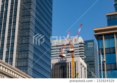 Looking up at the skyscrapers and tower cranes in Marunouchi Looking up at the skyscrapers and tower cranes in Marunouchi 132924329