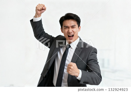 Businessman rejoicing at success with a fist pump 132924923
