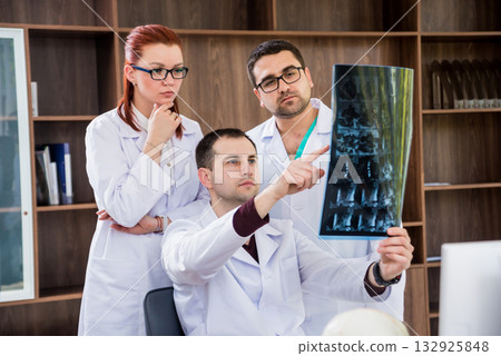 Doctors team having medical council in hospital. Discussing medical issues. Doctors team having medical council in hospital. Discussing medical issues. 132925848
