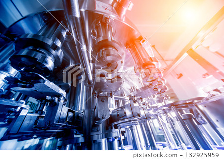 Automatic filling machine pours water into plastic PET bottles. 132925959