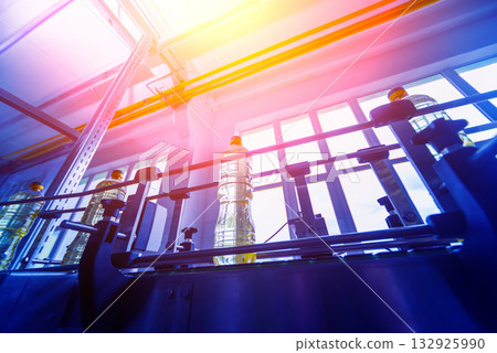 Bottling line of sunflower oil in bottles. Vegetable oil production plant 132925990