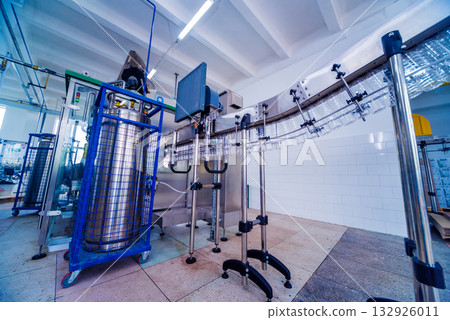 Bottling line of sunflower oil in bottles. Vegetable oil production plant.  132926011