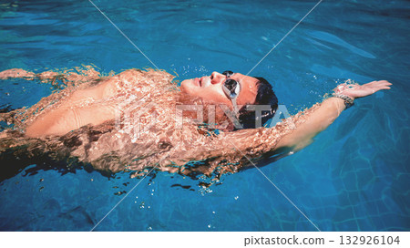 Young athletic man swimming in the swimming pool 132926104