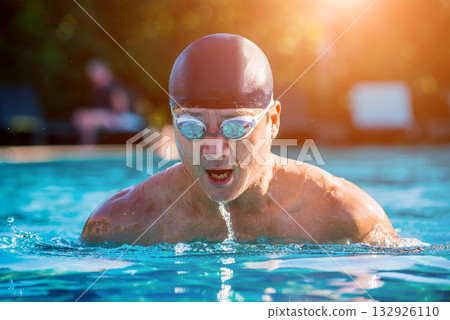 Young athletic man swimming in the swimming pool Young athletic man swimming in the swimming pool 132926110