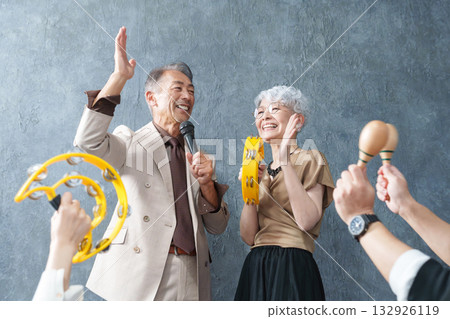 Elderly people singing enthusiastically at karaoke 132926119