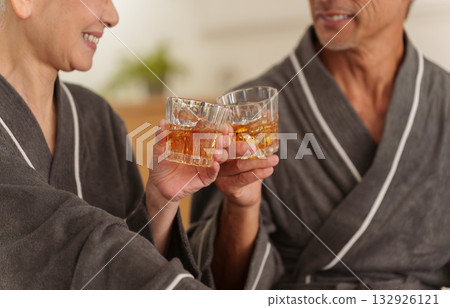 Senior couple having a drink in the bedroom (alcohol, drinking) 132926121