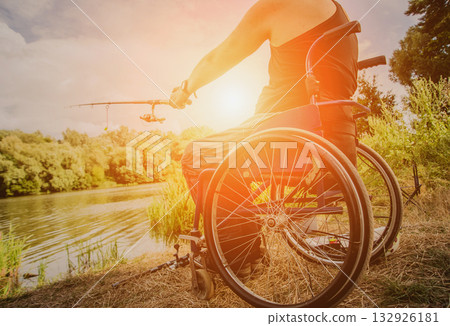 Handicapped man fishing at a lake. Wheelchair camping. Handicapped man fishing at a lake. Wheelchair camping. 132926181