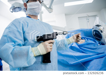 Arthroscope surgery. Orthopedic surgeons in teamwork in the operating room  132926236