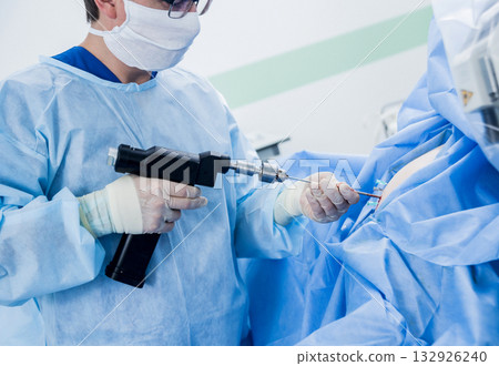 Arthroscope surgery. Orthopedic surgeons in teamwork in the operating room Arthroscope surgery. Orthopedic surgeons in teamwork in the operating room 132926240