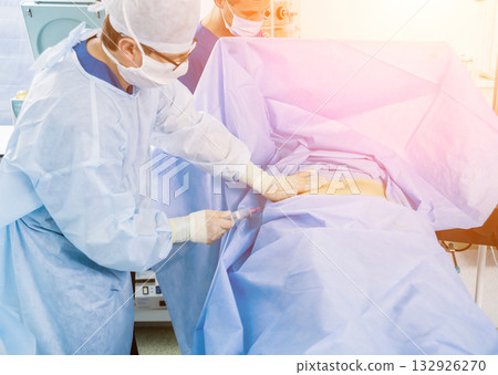 Arthroscope surgery. Orthopedic surgeons in teamwork in the operating room 132926270