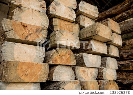 Stack of natural rough wooden boards. Wooden boards, lumber, industrial wood. 132926278