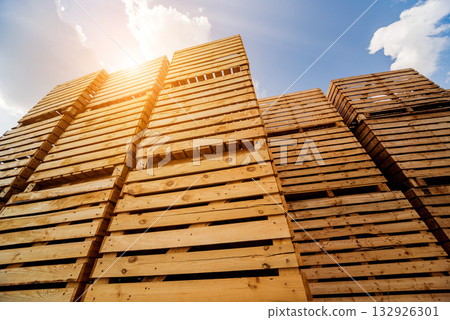 Wooden boxes stacked on each other. Outdoors. Blue sky background Wooden boxes stacked on each other. Outdoors. Blue sky background 132926301