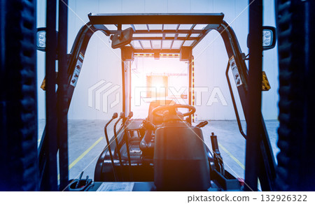 Forklift in a large industrial freezer warehouse. 132926322
