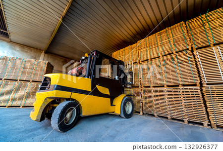 Forklift loader load lumber into a dry kiln. Wood drying in containers. 132926377