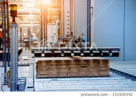 Production line of the wooden floor factory. CNC automatic woodworking machine. 132926392