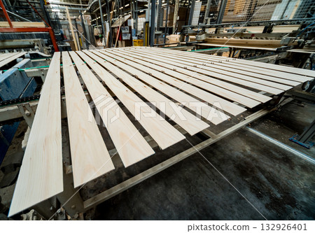 Production line of the wooden floor factory. CNC automatic woodworking machine. 132926401